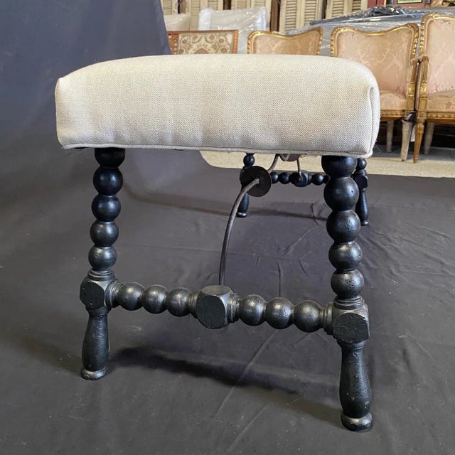 Exquisite ebony Spanish bench with turned wrought iron stretchers, a perfect addition to any contemporary or traditional...