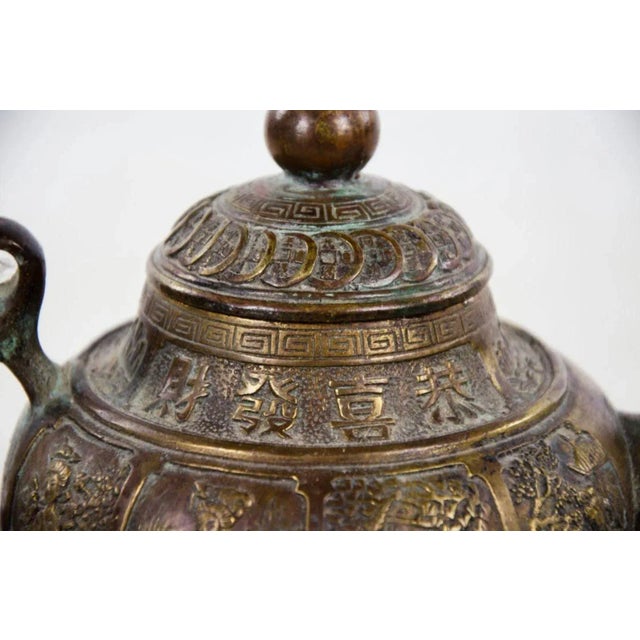 Antique Qing dynasty brass teapot, converted into lamp. Circa 1850s. This gorgeous lamp features wonderful deep relief...