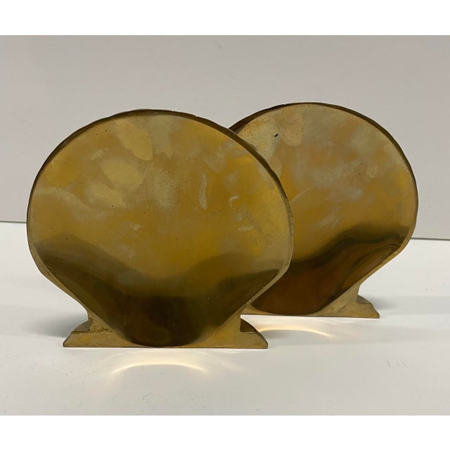 Pair of brass seashell form bookend produced by Andrea by Sadek. Marked on the bottom. 4.75 w x 1.5 d x 4.5 h inches each