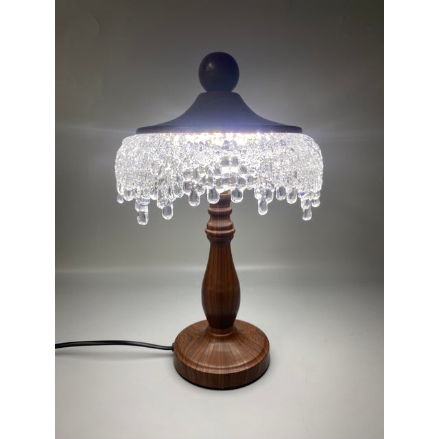 Lampshade with crystal tassel design (transparent teardrop crystals), paired with wood-grain metal pole + matching...