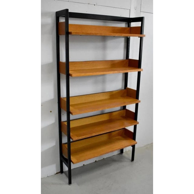 Vintage storage furniture from the 1970s in oak veneer. Its structure is made of tubular metal with a square section in...