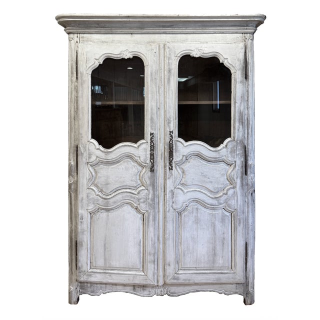 This French Provincial armoire is crafted in the Louis XV style, featuring a molded cornice above a pair of paneled...