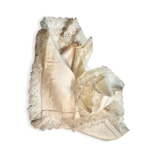 "A truly elegant ivory silk boudoir cloth, edged in hand-made lace, the kind of refined accessory that once graced a...