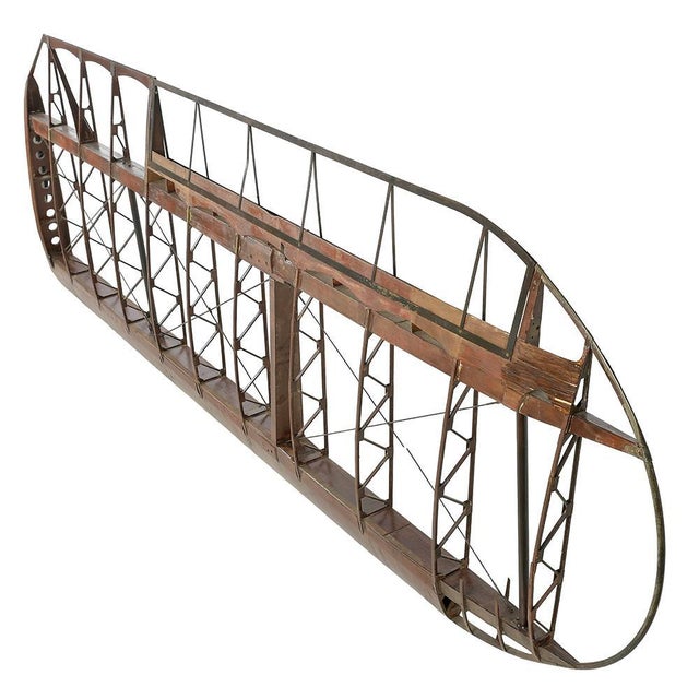 This impressive wing frame comes from an old aircraft, revealing the finesse of vintage aeronautical engineering....
