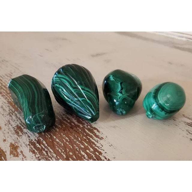 A set of 4 beautiful, natural, solid, and substantial hand carved and polished bright green malachite stones in various...