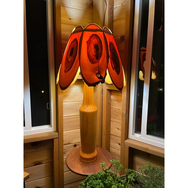 A stunningly beautiful and unique table lamp, with a base made from solid wood and shade made from eight thin, translucent...