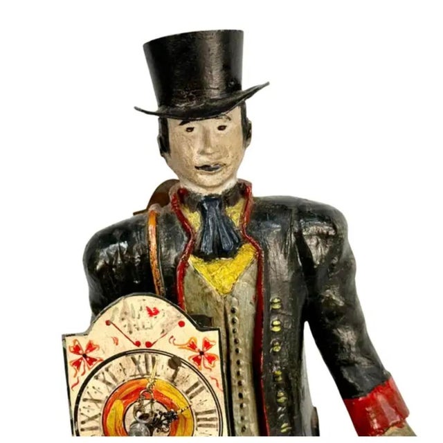 19th century Dutch figural peddler clock is characterized by a male peddler dressed in a black topcoat and top hat,...