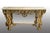 Richly carved console table with integrated mirror in Baroque style, dating back to the early 1970s. The mirror features...