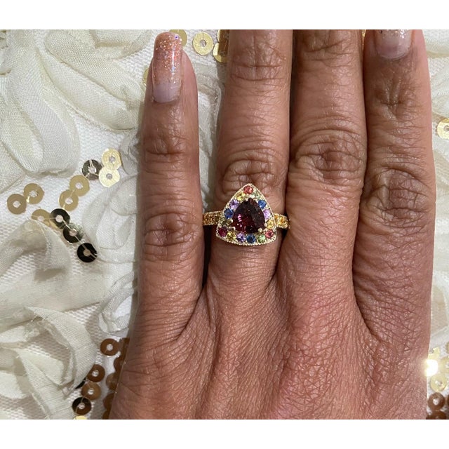 This ring has a Trillion Cut Tourmaline that weighs 1.14 carats and is surrounded by 27 Multicolor Sapphires that weigh...