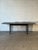 Beautiful vintage Danish Modern extendable dining table crafted from teak and refinished in a rich, dark stain that brings...
