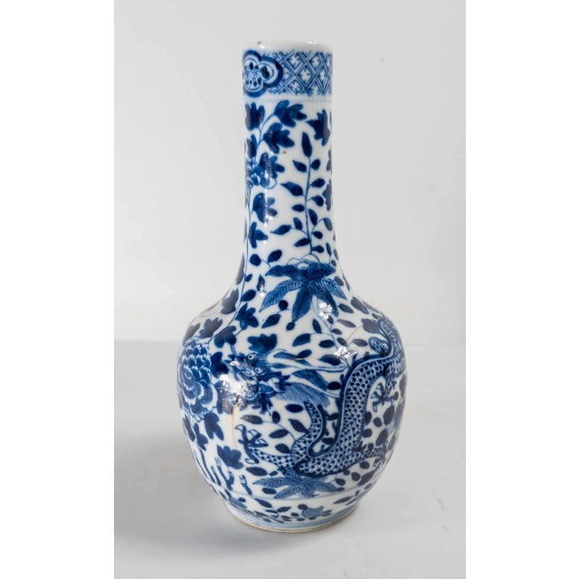 We are selling this well decorated Chinese underglaze Blue and White vase. This vase has simple peony and dragon...