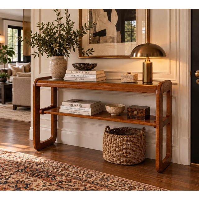 A stylish 1970s Mid-Century Modern console or sofa table designed by Lou Hodges for Mersman, featuring a warm oak...