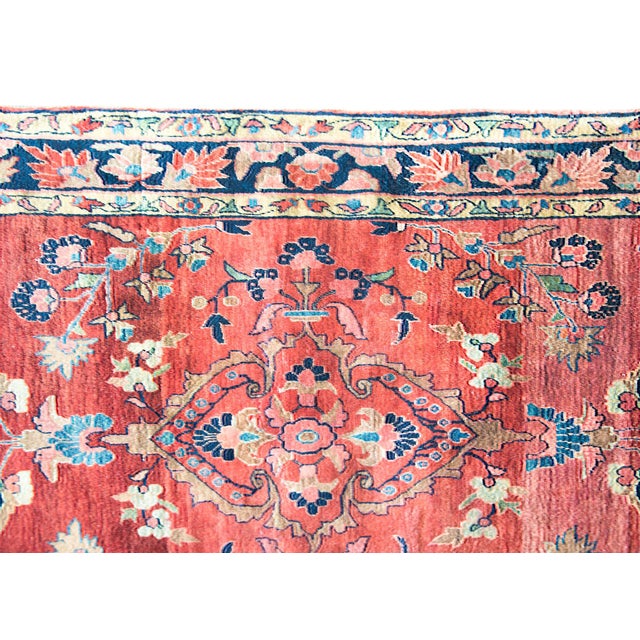 A gorgeous early 20th century Persian Sarouk Mohajeran rug with a large stylized floral central medallion amidst even more...