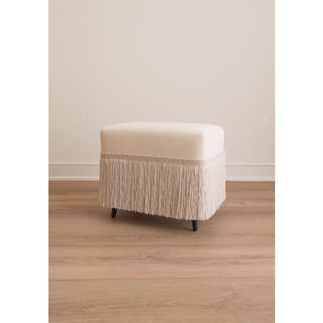 The Hutton is a cotton velvet upholstered stool, finished with a fringe trim in Dune. Crafted from richly variegated...