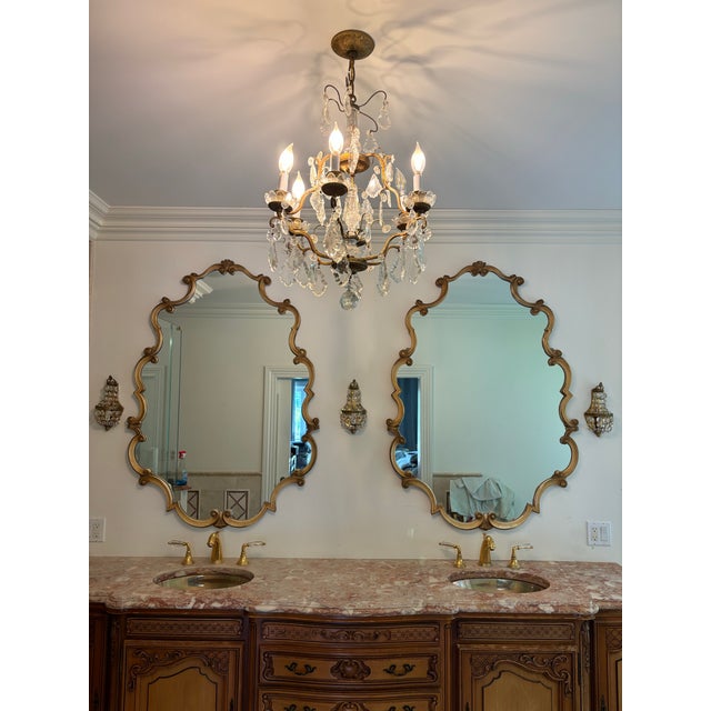 Large French Regency style framed mirror. Excellent workmanship with a wood backing and expertly carved scrolled frame.