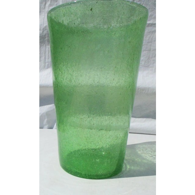 Bright green transparent cylinder vase. Seeded air bubble throughout the body, bright grassy green color with raindrop...