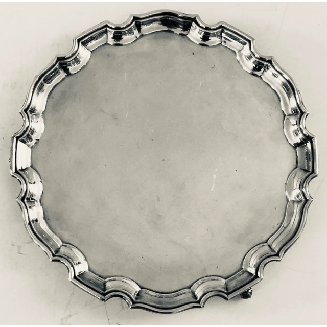 Silver plated pie crust serving tray elevated with three ball and claw feet. Great to serve cheese and crackers to petit...