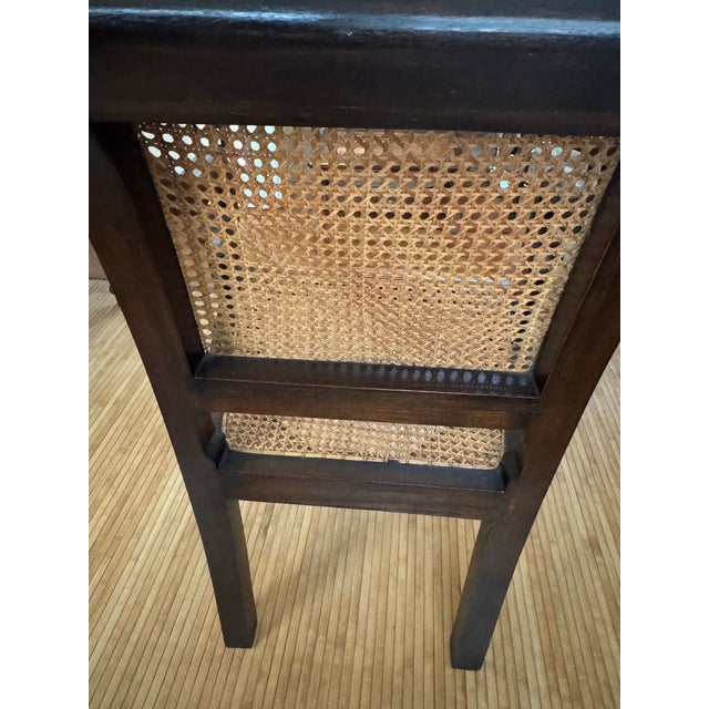 Elevate your space with these elegant armchairs, featuring intricate hand-carved woodwork, classic fluted legs, and woven...