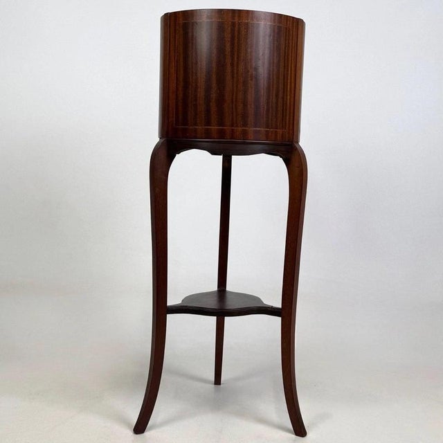 A handsome and finely crafted early 20th-century English Edwardian plant stand, beautifully constructed in mahogany and...