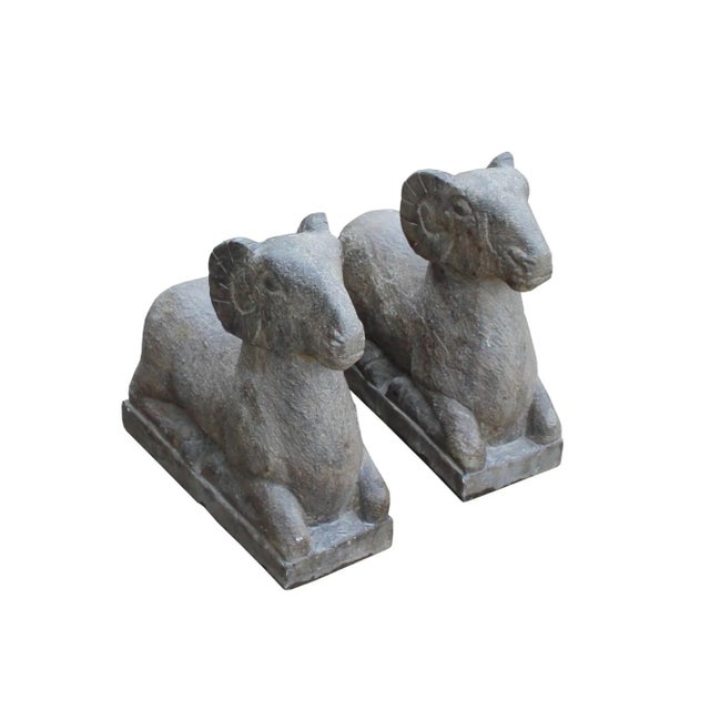 This is a pair of oriental Chinese stone statues of crouching Ram in vintage rustic distressed surface look. It is a mix...