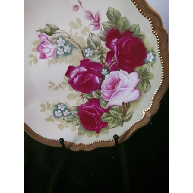 Beautiful Austrian ceramic gold gilded dinner plate. hand painted and signed "Martin", between the two red roses. Over 100...