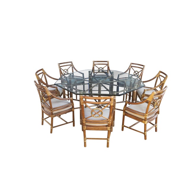 Monumental mid century modern dining table and eight chairs by McGuire Furniture. The table features octagonal form with a...