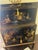 Chinoiserie Black Lacquer Cabinet / Dry Bar with Hand-Painted Gilt Scenes, Mid–Late 20th Century A striking Chinoiserie-...