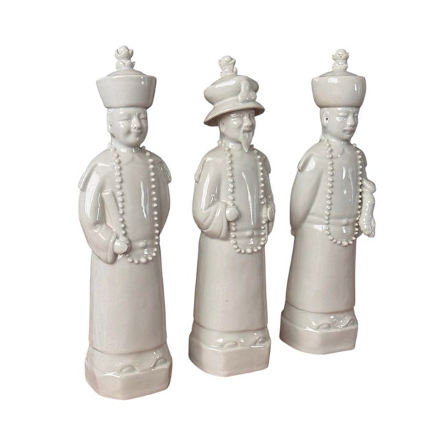 This exquisite set of three white porcelain Qing emperor figurines represents three generations, adding a refined touch to...