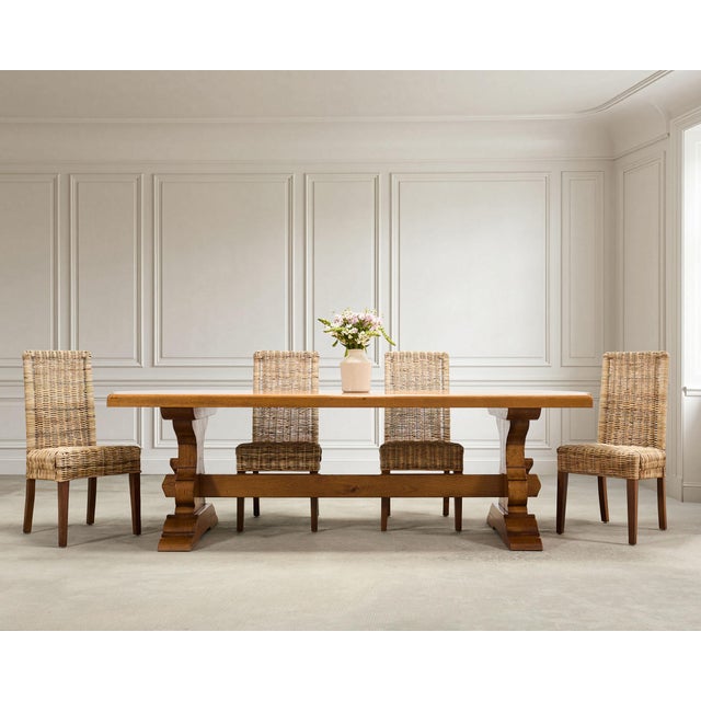 A grand and handsome oak trestle farmhouse dining table, crafted in a rustic French Provincial country style, measuring...