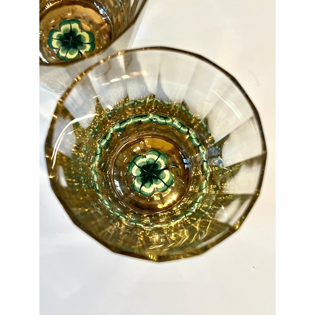 Crystal Decante, 5.5 diameter and 11" Tall, with four shot glasses. The decanter has perforations around the base and a...