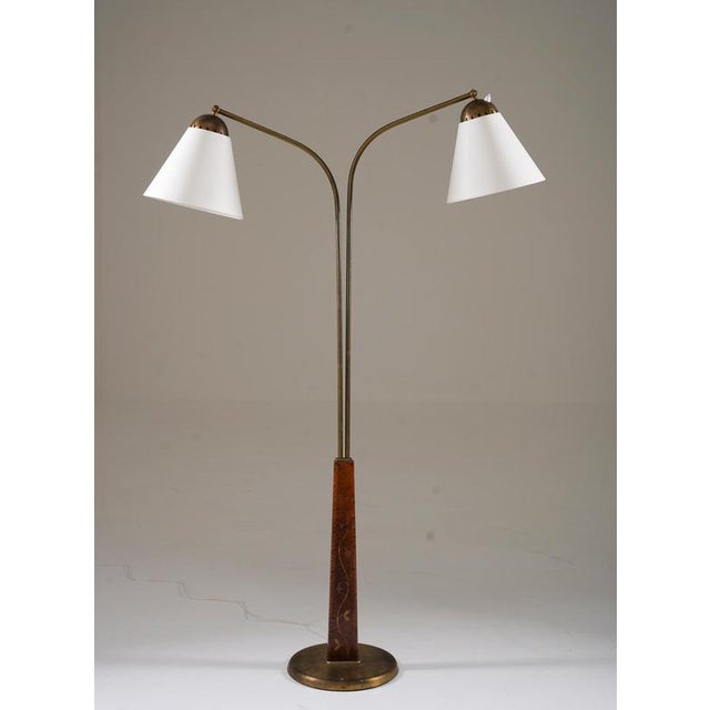A beautifully crafted swedish modern floor lamp, designed by tor wolfenstein for ditzingers in the 1940s. This elegant...