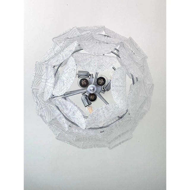 Luxury modern chromed chandelier with clear “petals” in murano glass with transparent "graniglia" that add more...