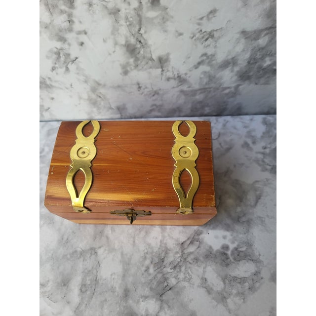 Adorable vintage wood box with brass detailing across the lid. Perfect decor for an office, on a stack of books or on a...