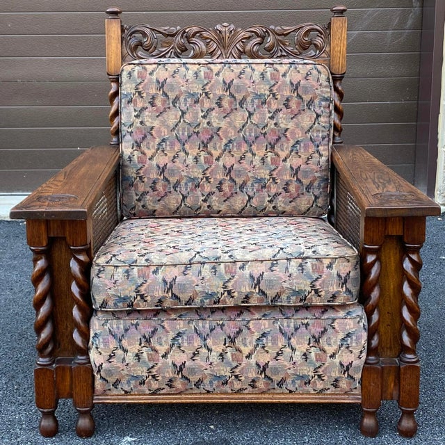 A unique hand carved oak lounge chair with caned sides and back and barley twist columns. Originally on six casters which...