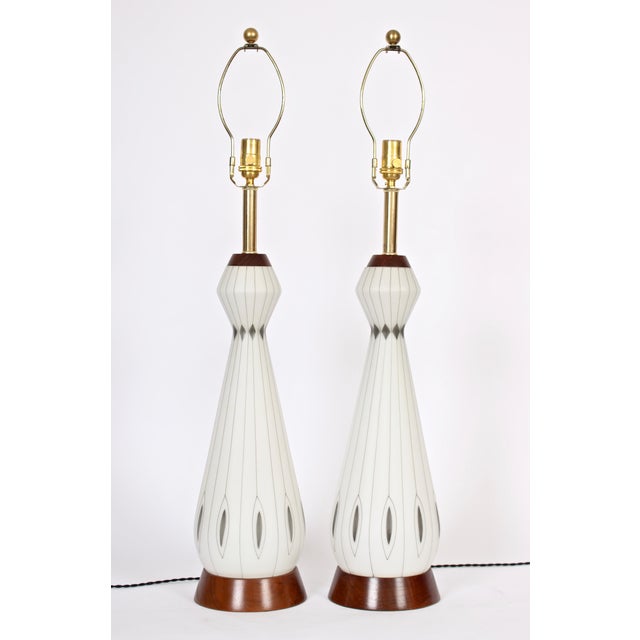 Majestic pair of 3' H white frosted glass table lamps with hand applied silver line. Featuring hand applied silver...