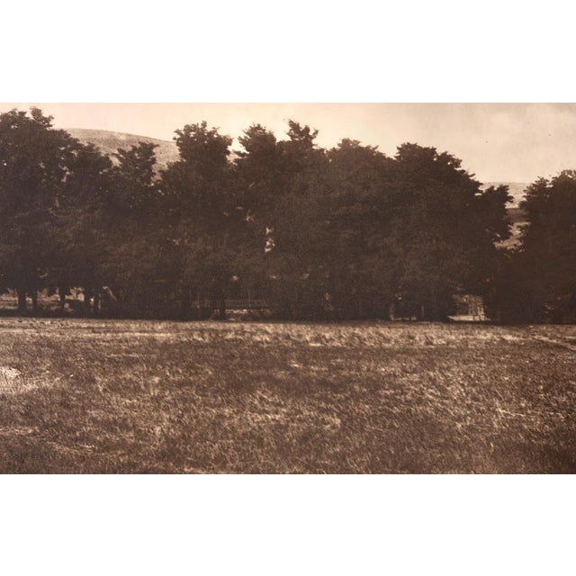 An original photogravure from Edward S. Curtis's The North American Indian. Fort Lapwai looks across an open, grassy field...