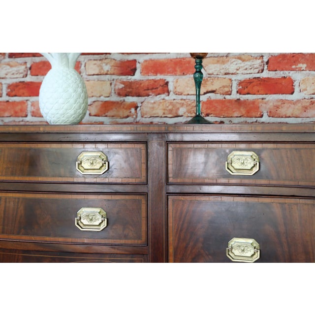 Absolutely stunning vintage mahogany Hepplewhite-style serpentine sideboard buffet manufactured by the prestigious...