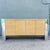 A striking postmodern credenza that masterfully blends sleek industrial design with organic textural detail. This...