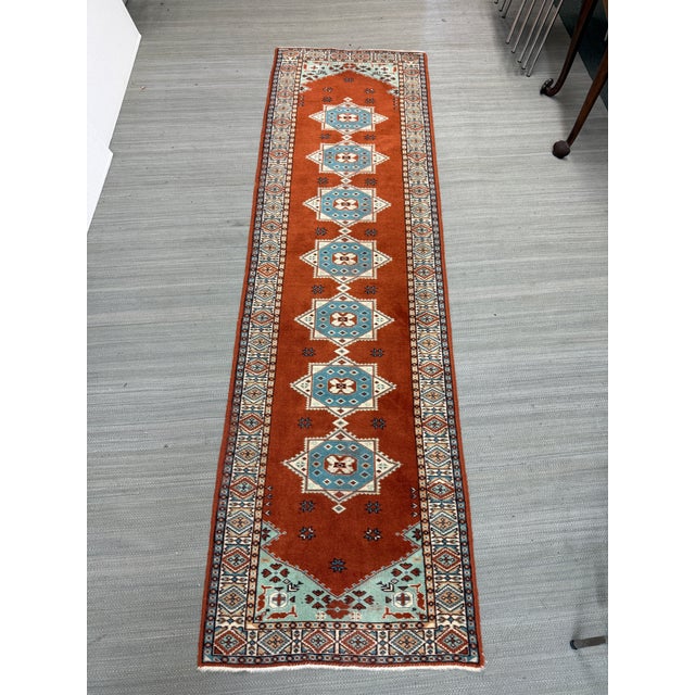 Design Plus Gallery presents a 2ft 7in × 9ft Wool Runner. The elongated profile is defined by a terracotta field framed...
