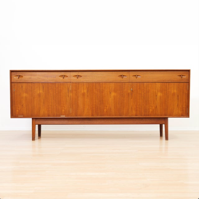 Designed by Malcolm David Walker for Dalescraft, this elegant mid-century sideboard is a fine example of British furniture...
