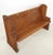 Reclaimed church pew bench made of oak with a dark tone finish, with Gothic carvings on each side. The arms have oval...