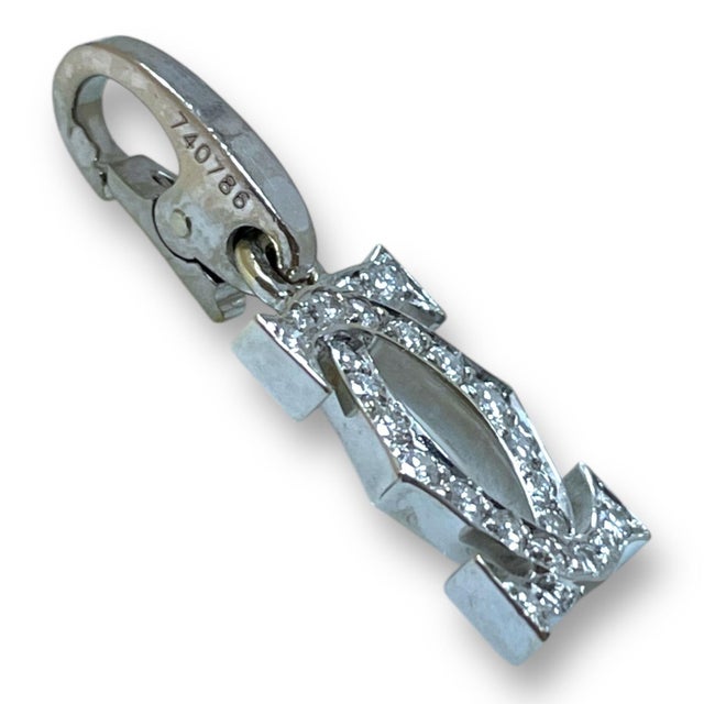 This exquisite Cartier pendant, crafted in 18K white gold, features the iconic double C logo adorned with brilliant-cut...