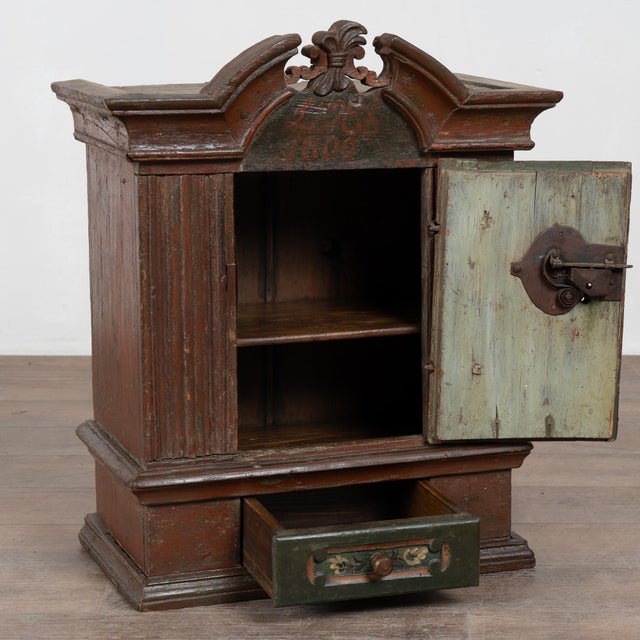 Original painted Swedish hanging cabinet dated 1800, crafted in pine with original hinges and a richly aged painted...
