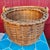 Antique hand-woven wood splint swing-handle basket, dating to the late 19th century, featuring a round body with a...