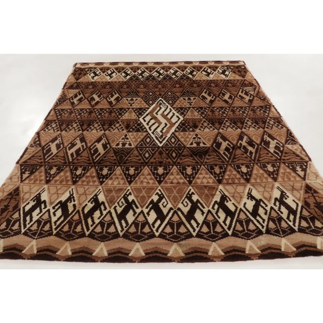 Hand-knotted in wool, this 8x10 vintage French rug, circa 1950–1959, features rhythmic geometric bands enriched with human...