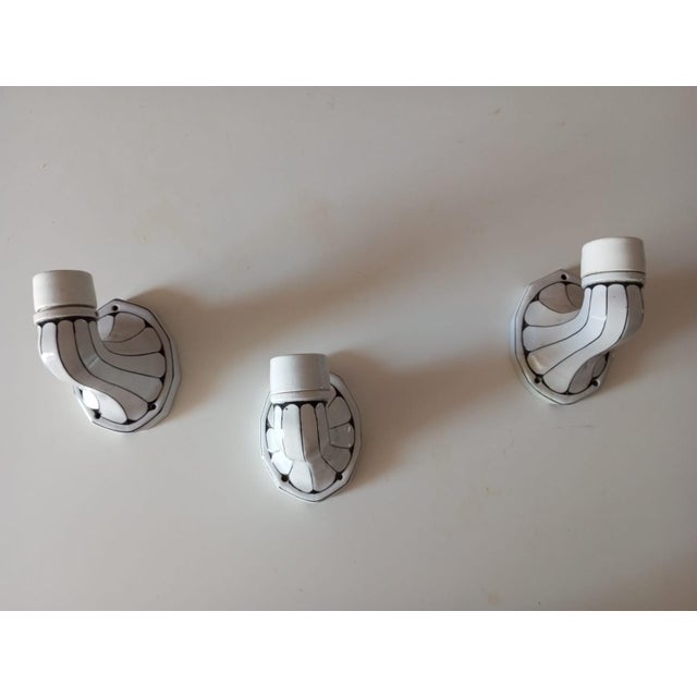 These wall sconces, made in the 1960s, are a refined example of Art Nouveau style. The enameled porcelain arm, featuring...