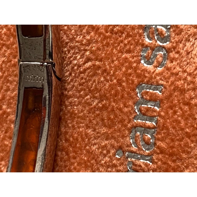 This Miriam Salat bangle features two tine wine color resin, solid and translucent with vintage sterling silver. Cubic...