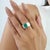 The Contemporary Wide-Band Octagon-Cut Green Emerald Statement Signet Ring features a striking 2.74 carat emerald in a...