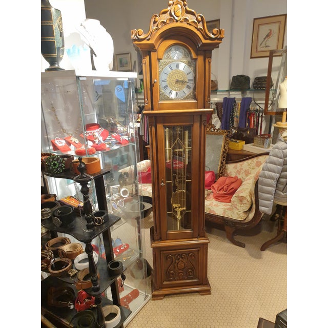 tempus fugit clock, 1980s, carved mahogany wood. dial with roman numbers, with lever to silence the chimes. This piece has...