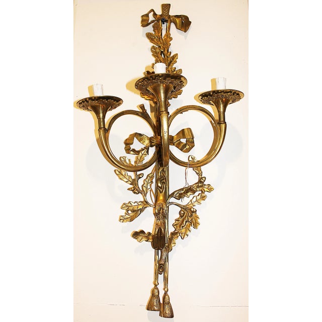 Louis XI-style three-arm solid brass sconce. Newly rewired and in working condition. Circa 1970s.